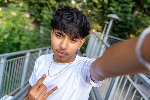 files/young-teenage-man-taking-a-selfie-in-an-outdoor-cafe-terrace-photo.jpg